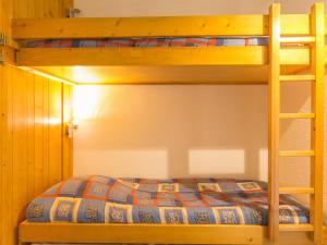 a bedroom with a bunk bed with a ladder at Studio Les Arcs 1800, 1 pièce, 5 personnes - FR-1-346-425 in Arc 1800