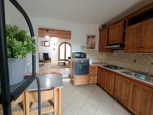 a kitchen with wooden cabinets and a blue stove top oven at Alle Porte del Chianti in Castiglioni