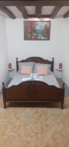 a bedroom with a large wooden bed in a room at Chez Mick in Pontlevoy