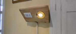 a light on a wall next to a door at Eco Inn in Cusco