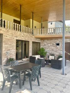 a wooden table and chairs on a patio at Lagostar in Lagodekhi