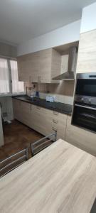 a kitchen with a table and a stove top oven at Apto San Francisco,en el centro y en la playa in Castro-Urdiales