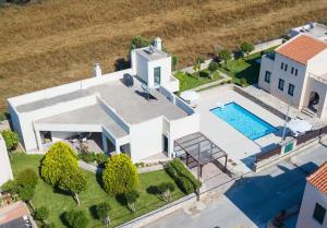 an aerial view of a house with a swimming pool at Villa Athina in Asprouliánoi