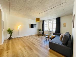 a living room with a couch and a table at aday - Frederikshavn apartment on the Pedestrian street in Frederikshavn