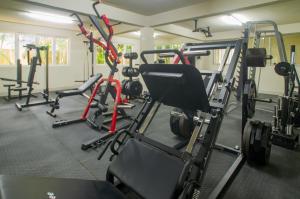 a gym with several tread machines in a room at Sunbay Hotel in Christ Church