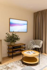 a living room with a tv on the wall at Birzes dzīvoklis (Birzes condo) in Cēsis