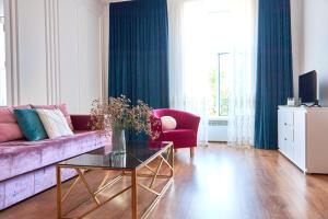 a living room with a purple couch and a table at Elegant Lux Apartment in central square in Mukacheve