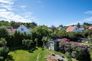 a view of a garden with flowers and trees at WHITE & BRIGHT Room in a shared apartment in Gothenburg