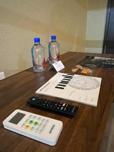 two remote controls sitting on top of a wooden table at Boxstel - Modern Stay Hotel Downtown El Paso in El Paso