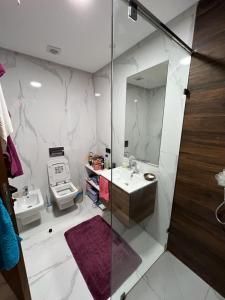La salle de bains est pourvue d'une douche, d'un lavabo et d'un miroir. dans l'établissement Seaside - Luxury Living, à Dar Bouazza