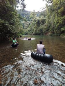 a group of people riding in tubes in a river at Vila Drávida in Iporanga