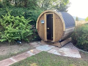 a wooden hobbit house sitting in a garden at Chalet Spessart in Dammbach