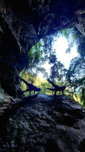 two benches sitting on a hill in a cave at Vila Drávida in Iporanga