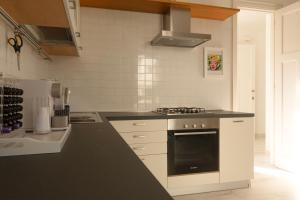 a kitchen with a black and white stove top oven at Civico89 in Pescara +28 photos