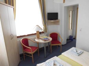 a hotel room with a table and two chairs and a bed at Burg Hohnstein in Hohnstein