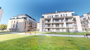 two buildings with benches in front of a park at Serenity Retreats VRT in Sibiu
