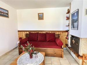 - un salon avec un canapé rouge et une table dans l'établissement Appartement Le Corbier, 3 pièces, 4 personnes - FR-1-267-246, à Villarembert