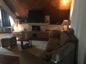 a living room with a couch and a tv at le fumoir de l' artisan Guest house in Antananarivo