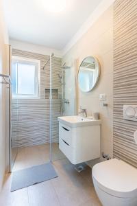 a bathroom with a toilet and a sink and a shower at New 4 star Room M&A in town Cres in Cres