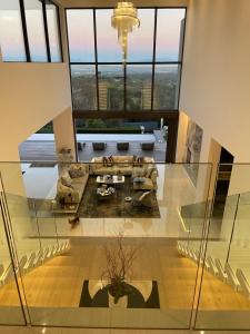 a large living room with a couch and a table at Camelot Villa in Cape Town