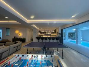 a living room with a ping pong table at Camelot Villa in Cape Town +137 photos