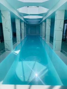 an empty swimming pool in a building with blue lighting at Camelot Villa in Cape Town