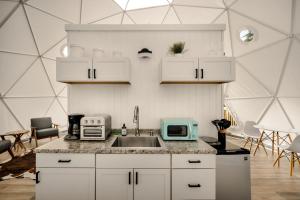 a kitchen with a sink and a microwave at Luxe Dome w Hot Tub, Full Bath & Mountain View in Augusta