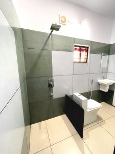 a bathroom with a toilet and a sink at Abode Homestay Alleppey Near Omanapuzha Beach in Alleppey +27 photos