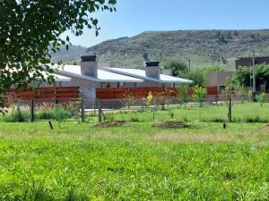 una casa con un campo delante de ella en ALOHA, en Sierra de la Ventana