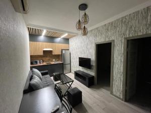 a living room with a couch and a kitchen at ByurHouse in Byurakan