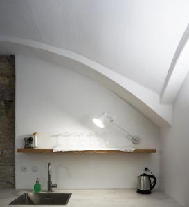 a kitchen with a sink and a white ceiling at Old Town Flat with Private Patio in Kutná Hora +10 photos