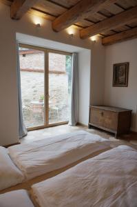 a bedroom with a large bed and a window at Old Town Flat with Private Patio in Kutná Hora