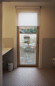 a door leading to a patio with a table outside at Old Town Flat with Private Patio in Kutná Hora