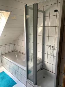 a bathroom with a bath tub in a attic at Ferienwohnung Klara in Meßstetten