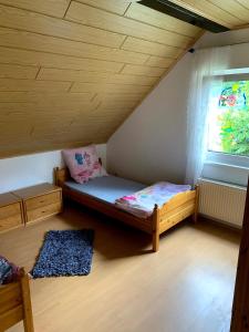 a small room with a bed and a window at Ferienwohnung Klara in Meßstetten