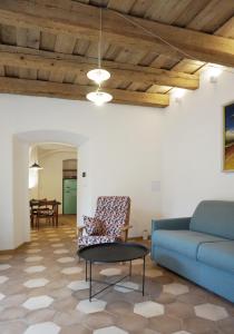 a living room with a blue couch and a table at Old Town Flat with Private Patio in Kutná Hora +10 photos