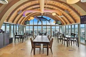a dining room with tables and chairs and windows at Endless Summer! Incredible Water Views in Miami