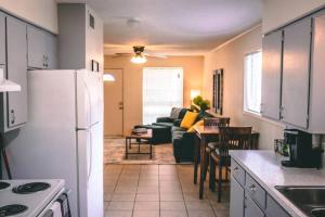 a kitchen with a white refrigerator and a living room at Bronze Star on Fairway in Longview