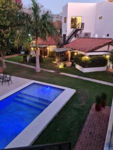 a backyard with a swimming pool and a house at La Pinta Hotel Boutique in San Bernardino