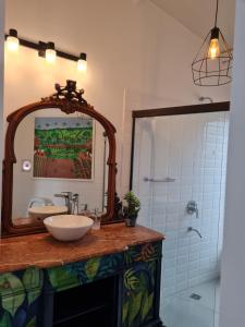 a bathroom with a sink and a mirror at La Pinta Hotel Boutique in San Bernardino