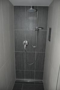 a shower with a shower head in a bathroom at Flierelerhof in Arzl im Pitztal +31 photos
