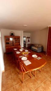 a large wooden table in a room with chairs and a tableablish at Casa Abuelo Antonio in El Cotillo