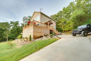 a truck parked in front of a wooden house at Hot Tub and Fire Pit! Lake-View Home in Blue Eye in Blue Eye