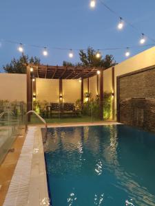 a swimming pool in a backyard with a house at منتجع ديفان 