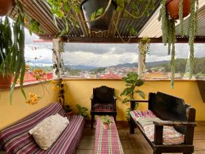 a room with two beds and a window at El Calvario Hostal in Cobán