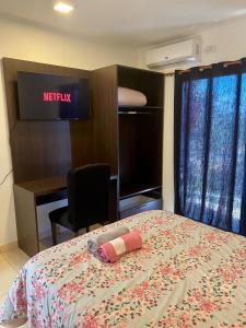 a hotel room with a bed and a desk at Mandua in Puerto Iguazú