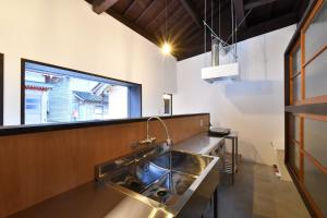 a kitchen with a sink and a window at Togiso 能登の古民家宿 in Togi