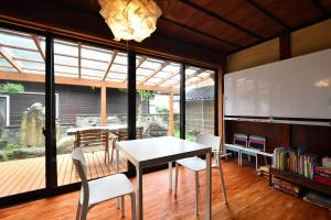 a dining room with a table and chairs at Togiso 能登の古民家宿 in Togi +17 photos