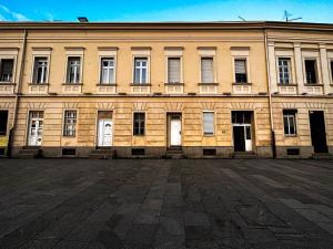 a large brick building with white doors and windows at Loft Sava View Old Town Renovated in Belgrade