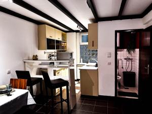 a small kitchen with a table and chairs in a room at Loft Sava View Old Town Renovated in Belgrade